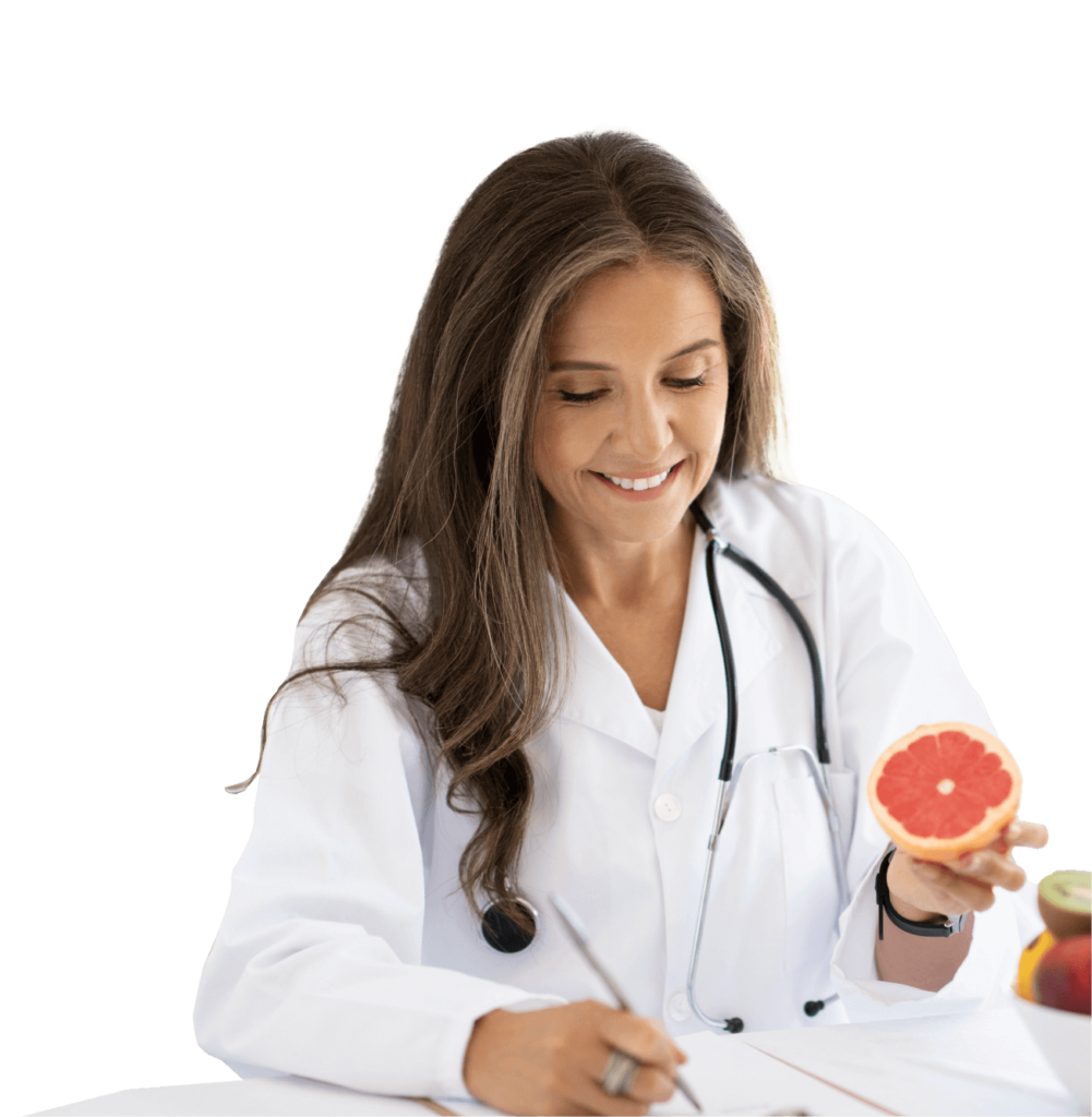 A female doctor in a white coat holding a grapefruit.
