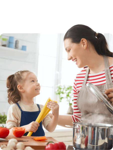 A dietician and a little girl cooking together in the kitchen.