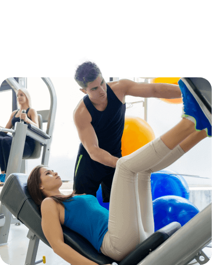 A woman and a man engaged in personal training at a gym.