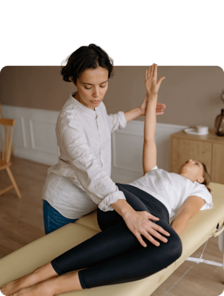 A woman is getting physiotherapy from a physiotherapist.
