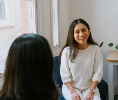 A woman receiving speech pathology services while conversing with the speech pathologist