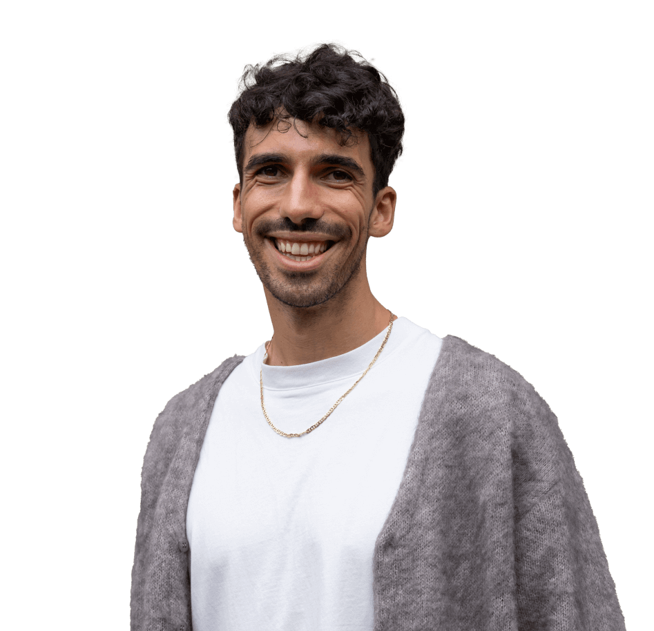 A smiling therapist wearing a grey cardigan.