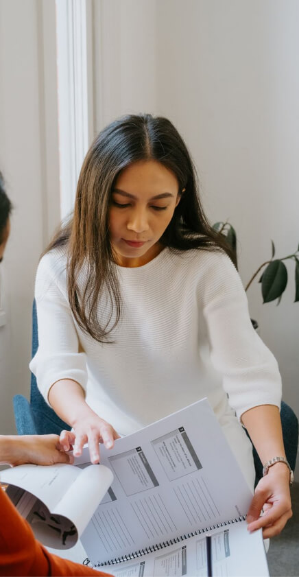 a health therapist looking at documents in an office.