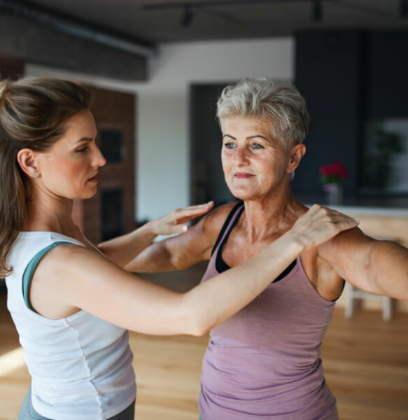 A woman and an older woman doing yoga in a Domain Health